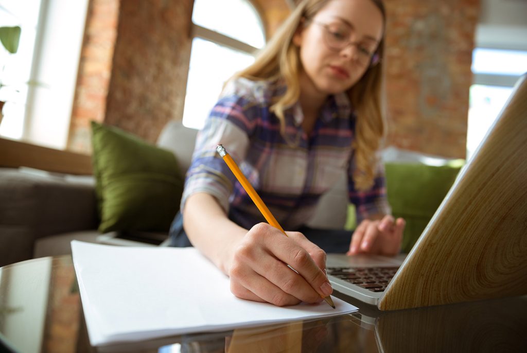 Individual writing answers to a quiz